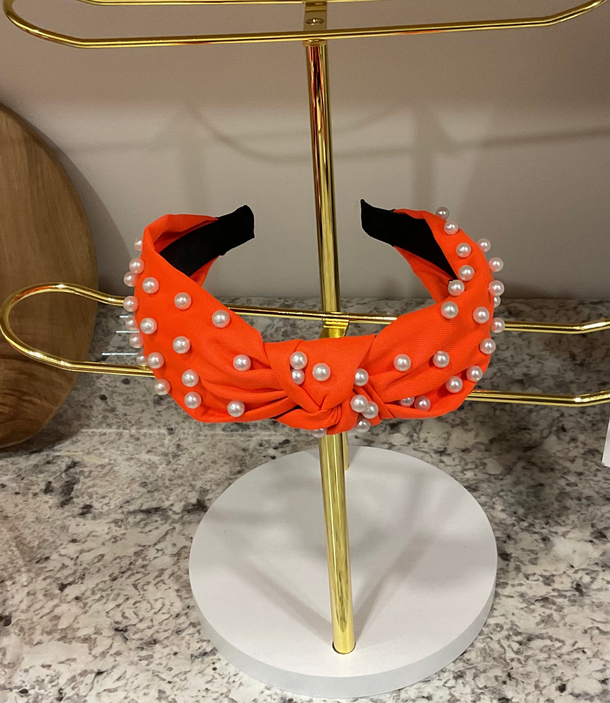000130 Orange knotted headband with pearls